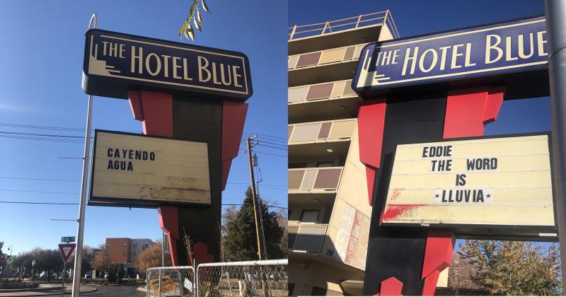 The Hotel Blue sign with a reader board that says "cuando" agua on one side and "Eddie, the word is *lluvia*" on the other