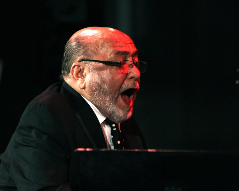 Man at piano singing