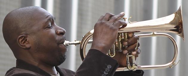 CLose profile of an African American man playing a trumpet