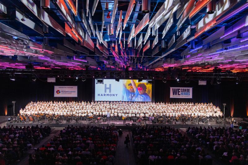 Photo of a large crowd watching a large choir onstage