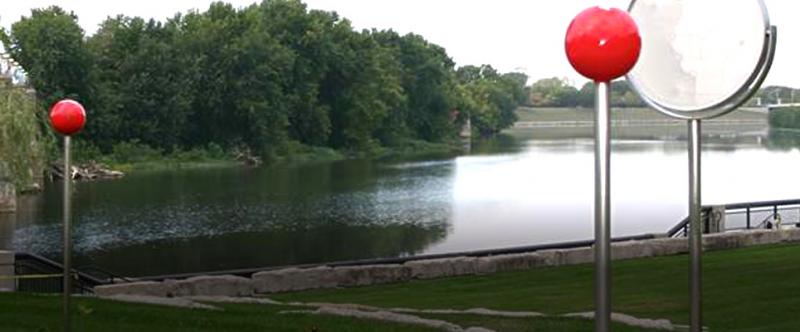 View of a rural river with decorative posts in the foreground