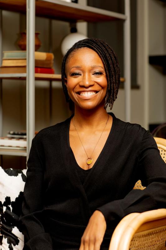 Katryna Carter, who is a youthful looking Black woman with short locs cut into a bob