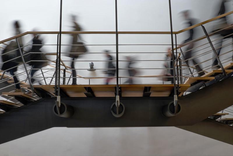 soft-focus photo of people using a metal stairway