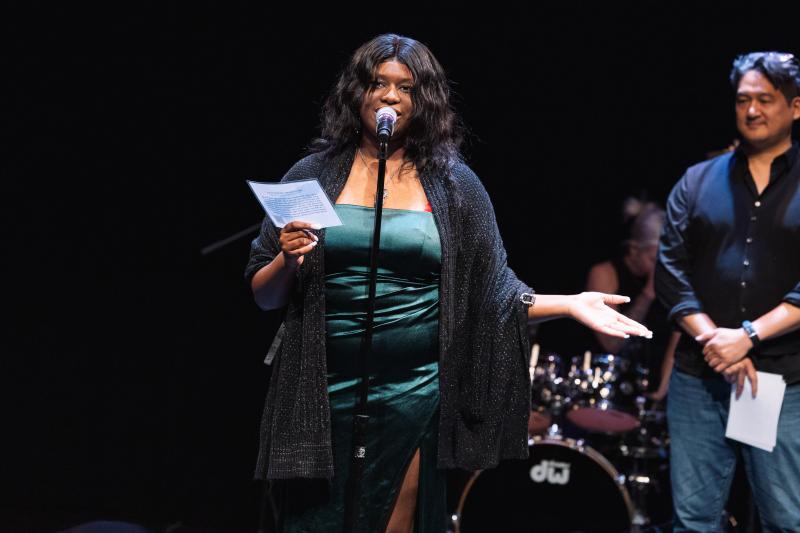 Tabitha Moore standing behind a microphone