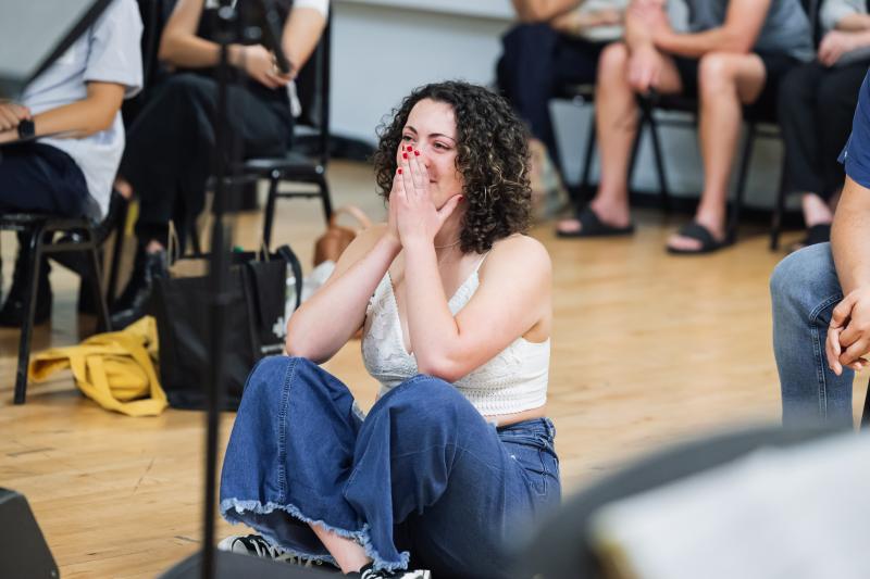 Gwendellyn Doerfler sitting on the floor of a studio during rehearsals of her original song