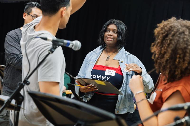 Tabitha Moore providing feedback during rehearsals of her original song, “What Did Love Do to You?”