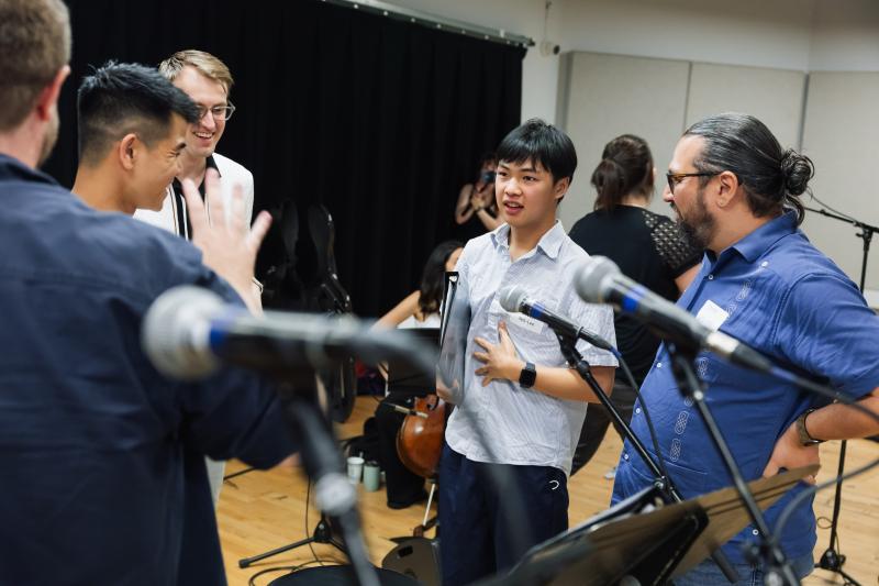 Owen Yeh-Lee providing feedback during rehearsals of his original song, "Spacetime."