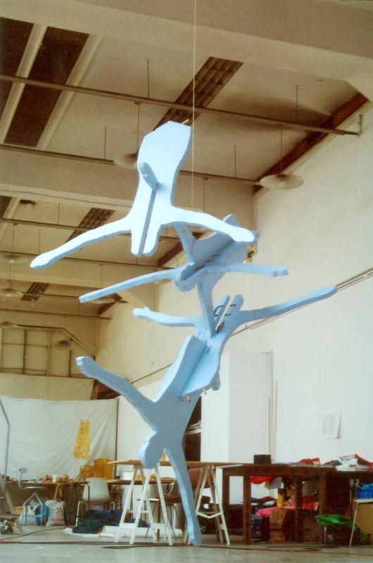 photograph of blue cutouts of people joined together like a 3D puzzle