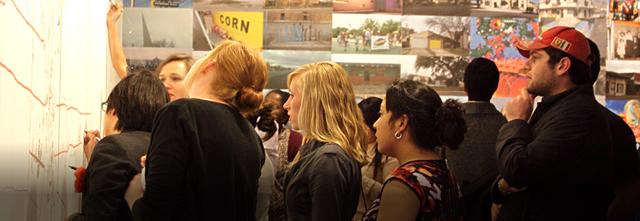 Group of people participating in drawing up ideas on a large easel page