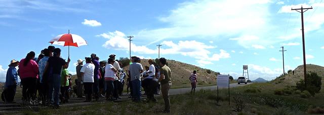 Small group of people making their way down a rural road