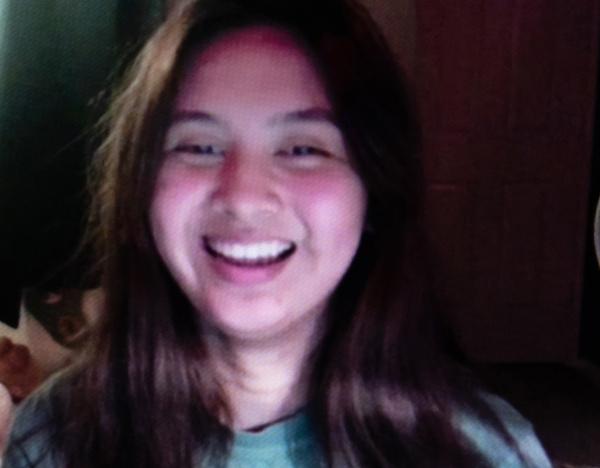 Headshot of a young woman smiling.