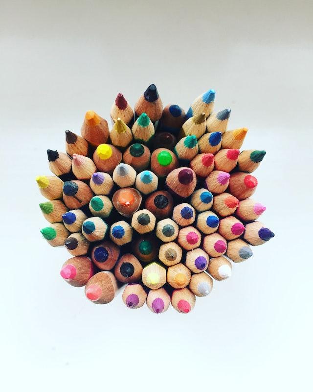 a view from the top of colored pencils with the writing ends pointed up
