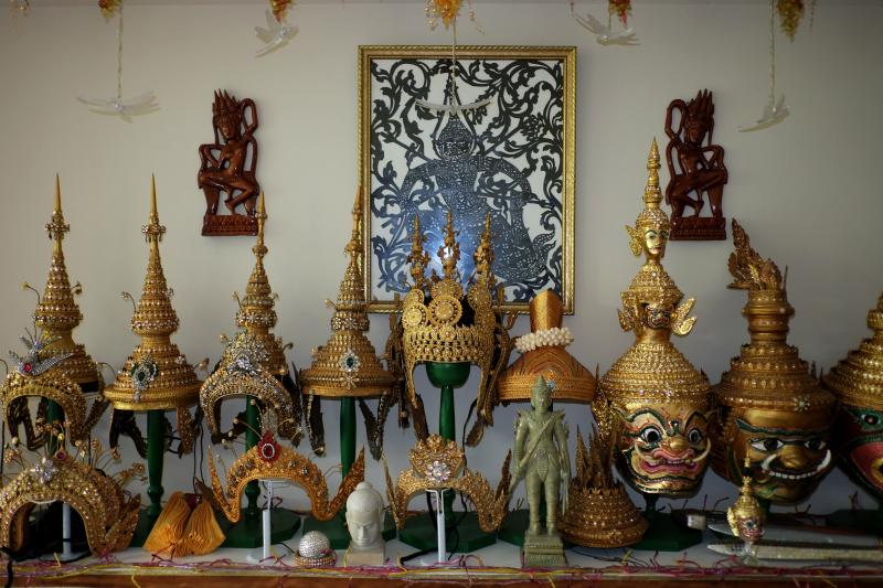 Masks and head dresses on a shelf.