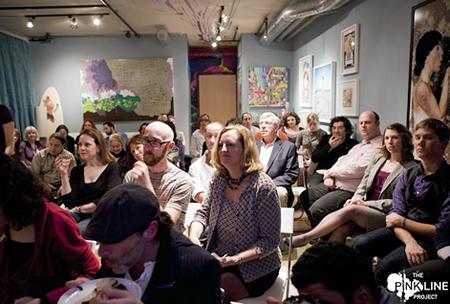Group of people in a salon setting listening attentively