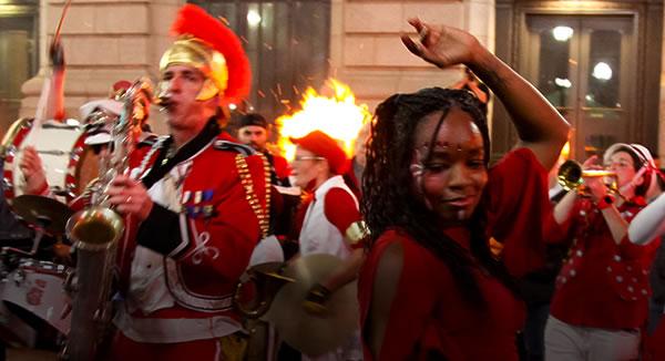 Street festival with musicians, dancers, and other performers