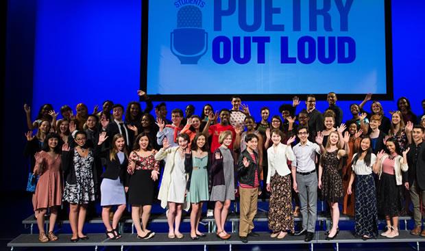 Group photo of a large group on stage.