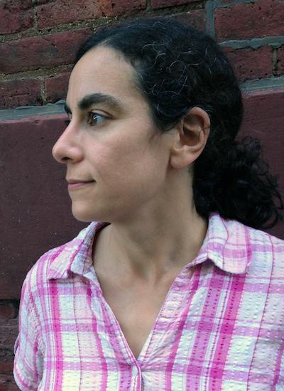 a profile photo of a youngish white woman with a long dark ponytail wearing a pink plaid shirt