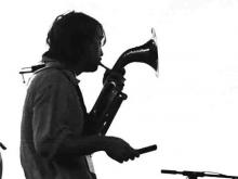 Man playing a horn on stage. 
