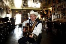 Country singer with guitar sitting