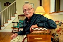 Joe Derrane at home with his accordion