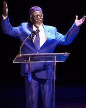 Older African American man speaking at a podium