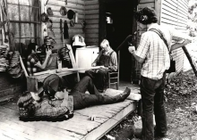 Film crew recording an elderly man on his porch