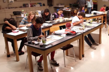 Young students working on paintng in a classroom