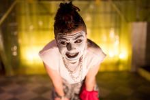 A teenager in heavy stage makeup onstage