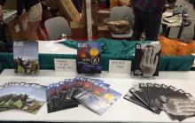 a conference table with various issues of NEA Arts magazine