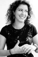 a young white woman with long dark curly hair