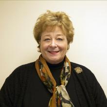 headshot of older white woman with short reddish hair