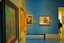 Museum hallway lined with paintings