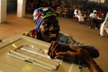An excited Liberian woman casts her presidential ballot in 2005