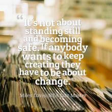 A Miles Davis quote over the interior of a record store: It's not about standing still and becoming safe. If anybody wants to keep creating they have to be about change.