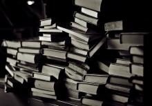Black and white photo of stack of books