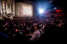 a crowded vintage-looking theater of mostly Asian-American people