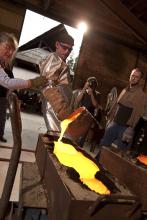 Photo - a woman and man at a glass casting demonstration at the Pilchuck Glass School.