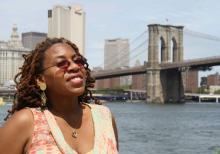 Woman standing in front of Brooklyn Bridge