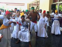 Dancers wearing white dresses and head scarves performing