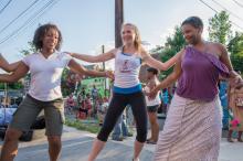 three women dancing outside