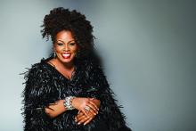 African-American woman wearing black furry dress. 