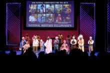 a group of diverse people on a lit stage