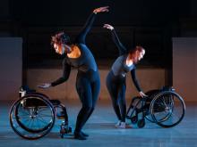 Two disabled dancers dancing with wheelchairs