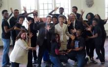 Theater students surrounding NEA chairman Jane Chu