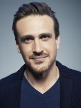 a young white man with short dark hair, brown eyes, and a light beard and mustache