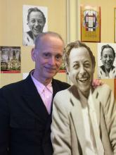 Actor John Waters poses with cardboard cut-out of Tennessee Williams