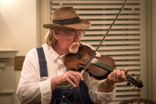A man playing the fiddle.