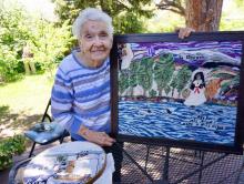 Josephine Lobato holding a piece of her embroidery