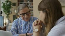 Ruth Bader Ginsburg and her granddaughter sitting at a table