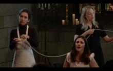 Three female opera singers perform in what looks like a church